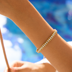 Gleam Bracelet in gold worn alone on wrist