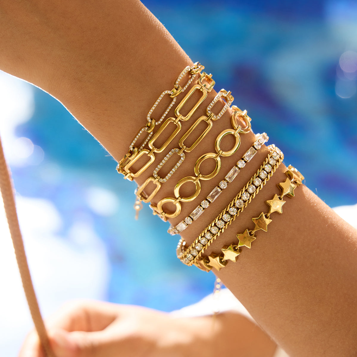 Gleam Bracelet in gold worn in a mixed jewellery stack