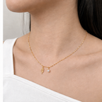 Mini Star Chain in Gold styled with two charms on a model