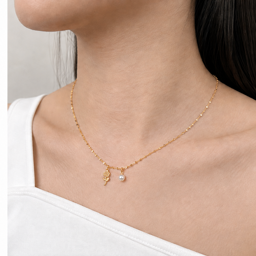 Mini Star Chain in Gold styled with two charms on a model
