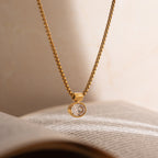 Miranda Chain in gold styled on a book