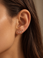 Shooting Star Studs in gold worn alone on ear