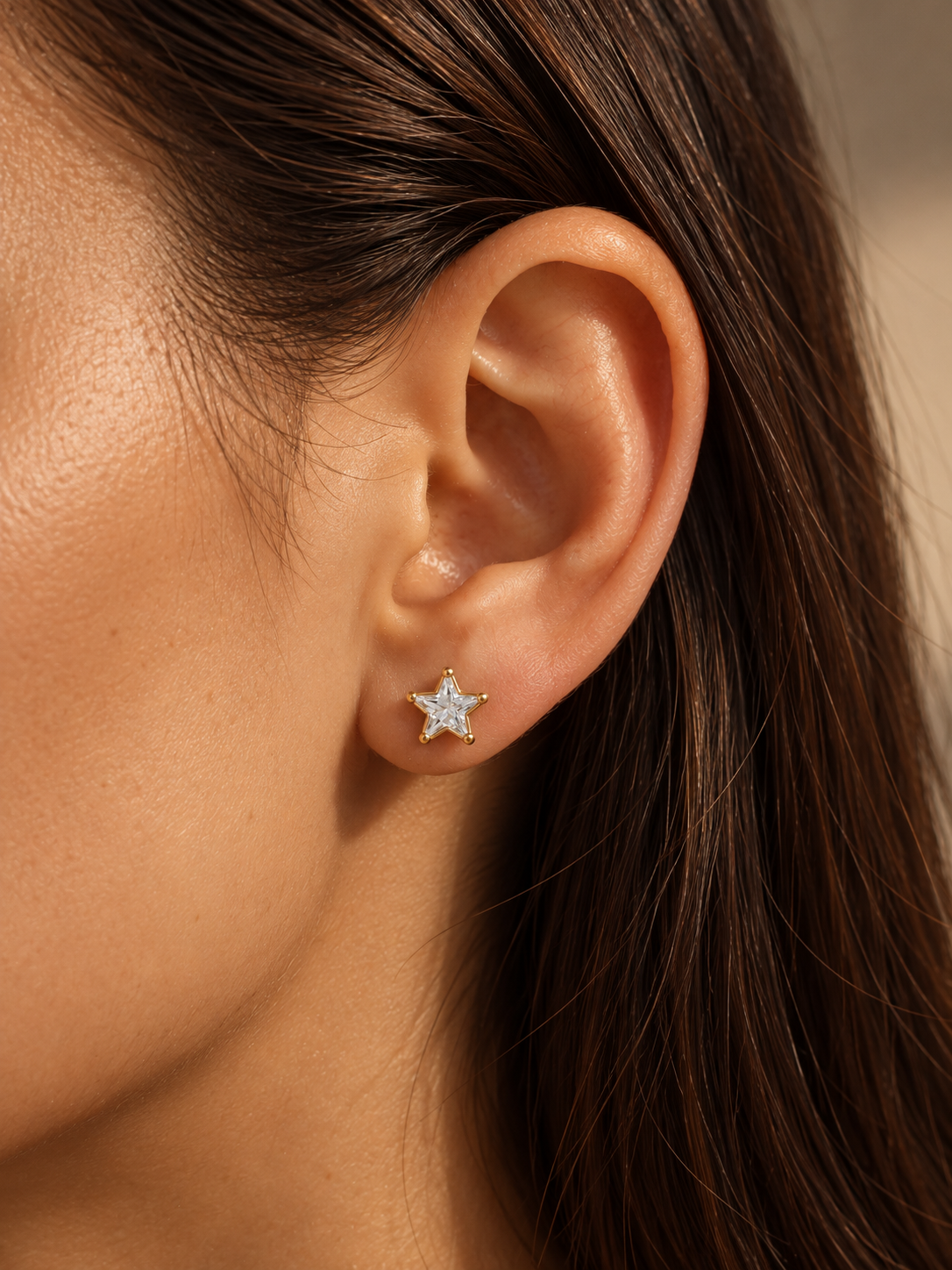 Star Studs in gold worn alone on ear